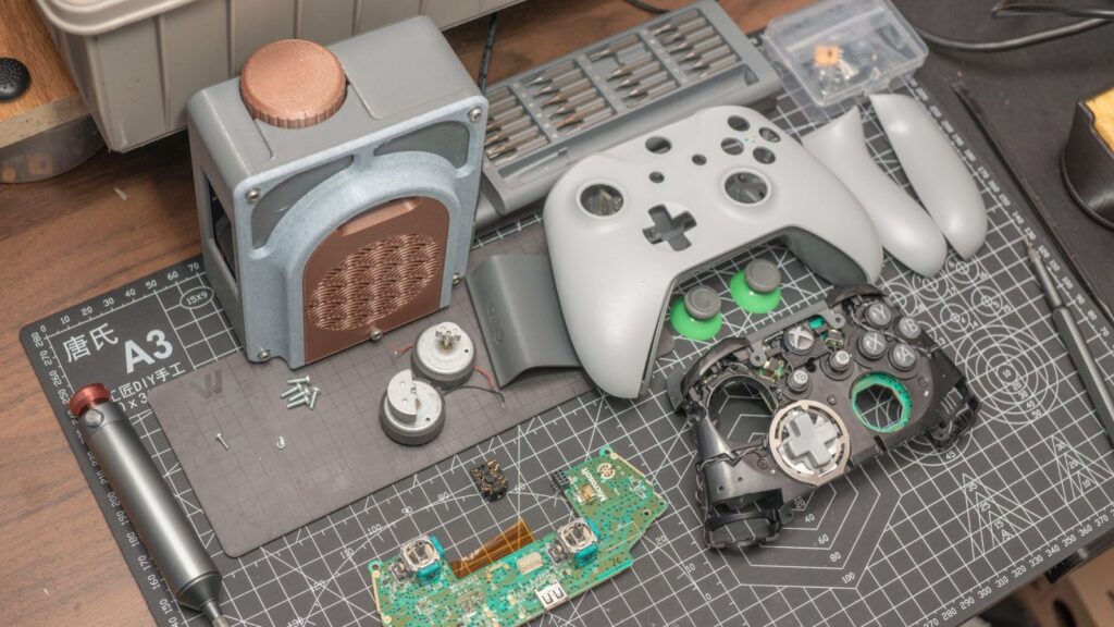 A technician repairs a game console at the elMeistrai service center in Žirmūnai, Vilnius