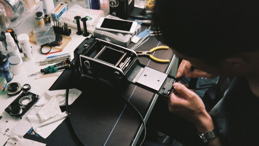 Camera lens and body on a workbench