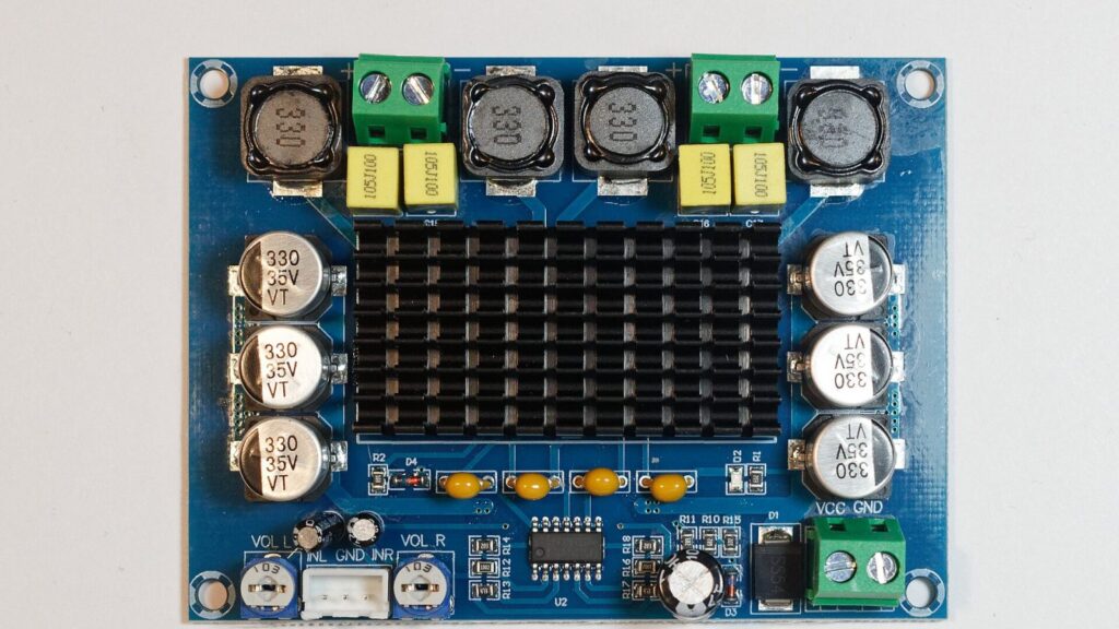 A technician inspects an audio amplifier board at the elMeistrai service centre in Kaunas