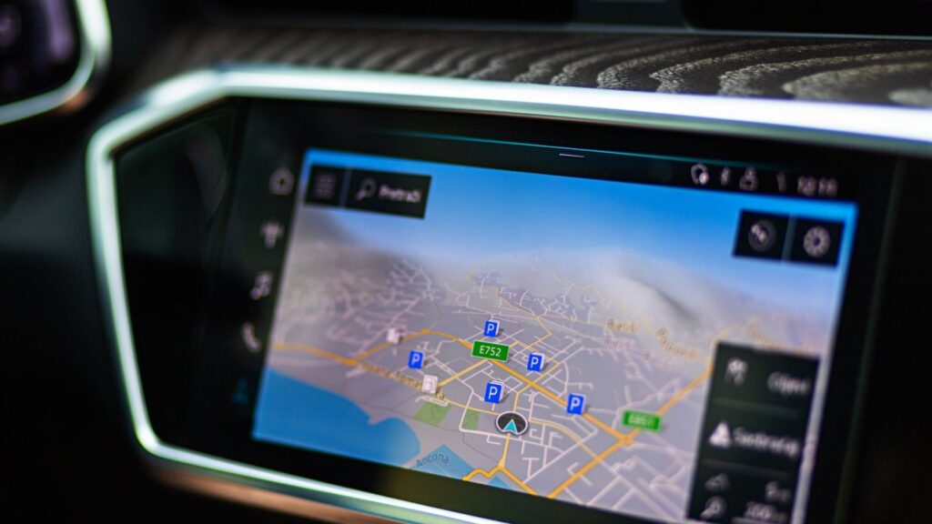 A technician checks the car navigation unit in the workshop